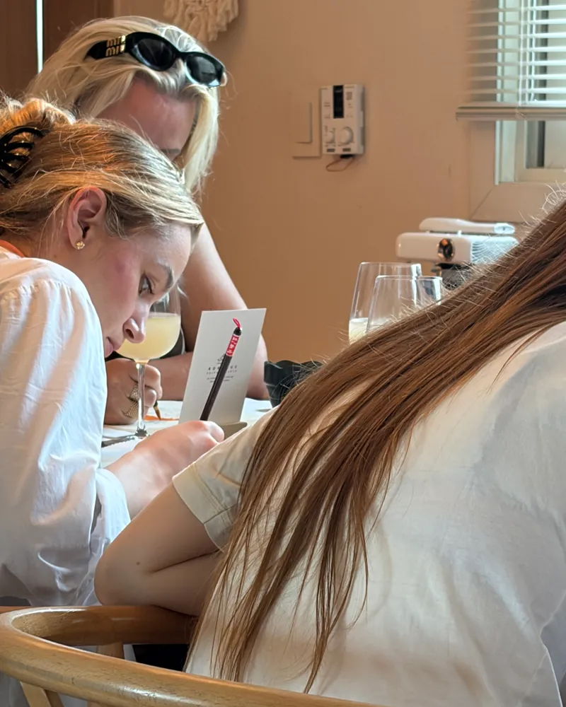 Guests bent over their work at the table