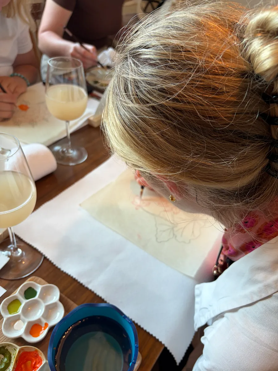 A guest drawing the outline of a Minhwa piece