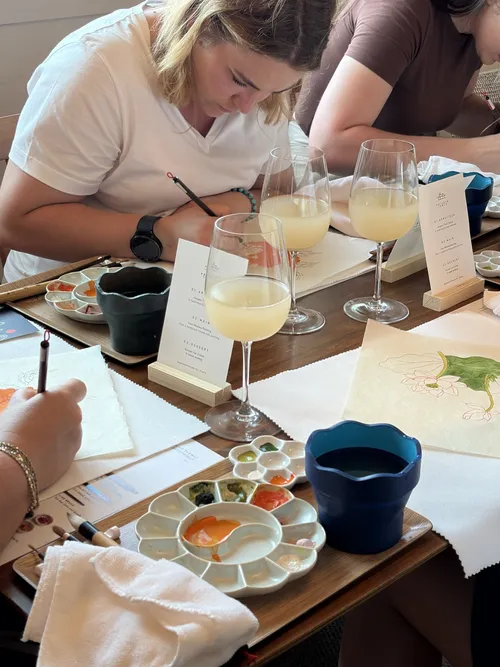 A guest painting beside a palette