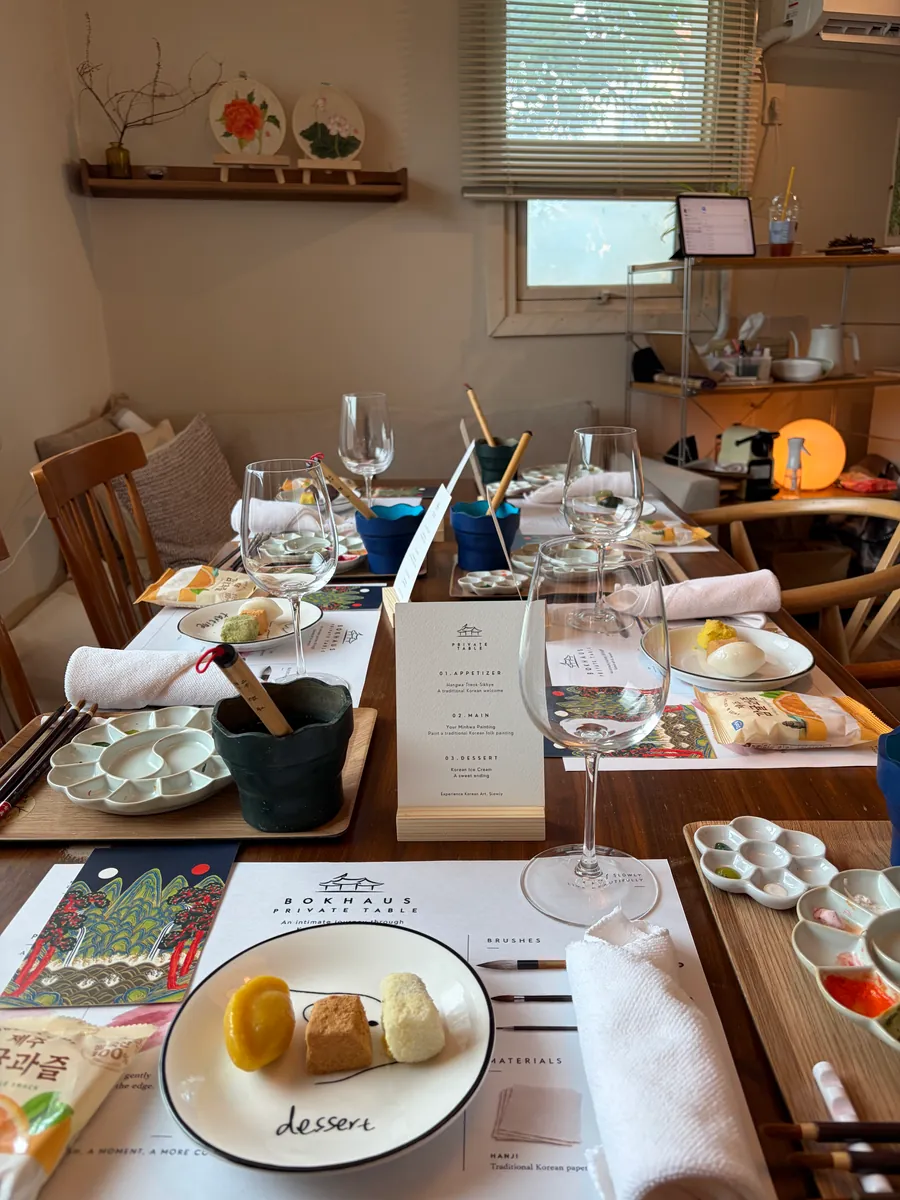A table set with place settings, palettes and printed menu cards